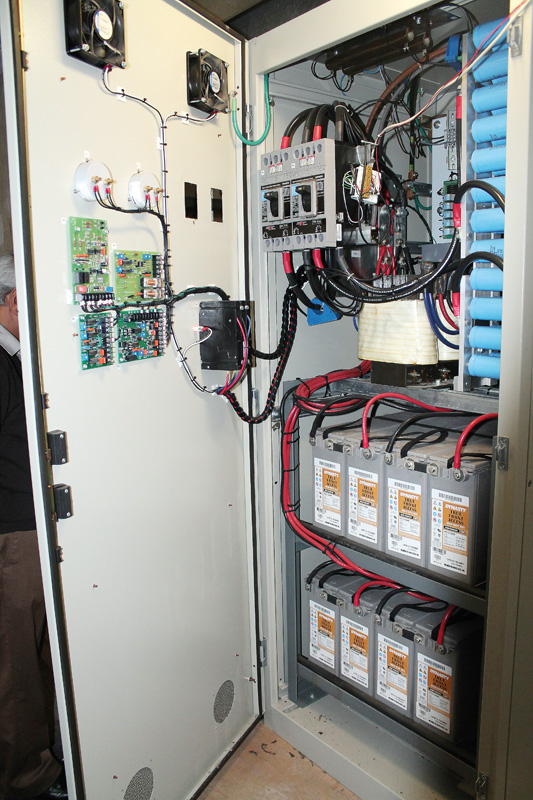 The one-tonne cabinet sits on the floor above the library’s computer bank. Three-phase AC is fed into the convertor as seen at the top of the cabinet and the  lead-acid batteries for UPS are below.