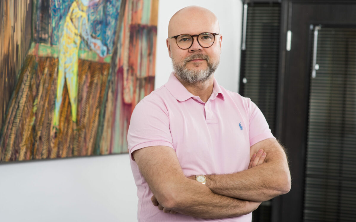 head and shoulders of man with arms folded
