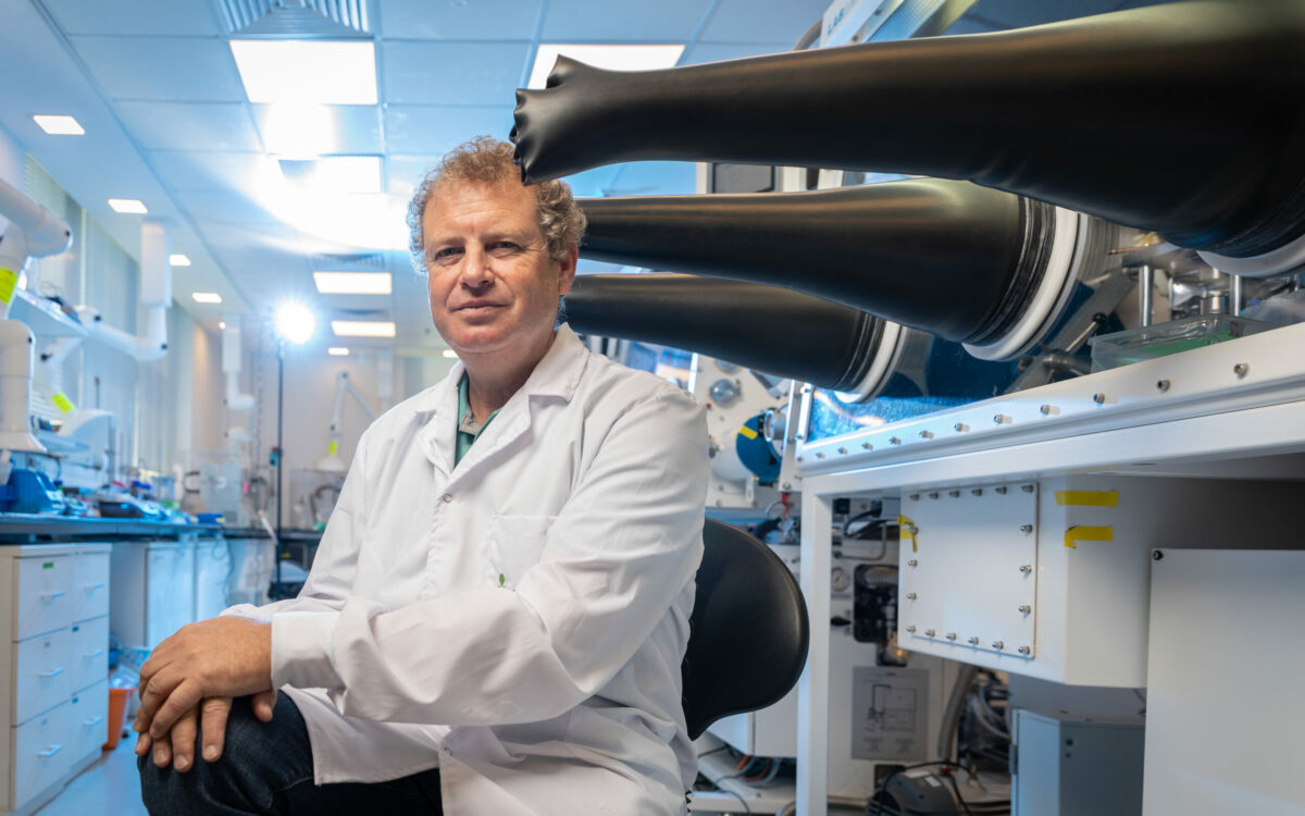 man in white lab coat sitting