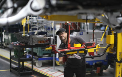Worker on car production line