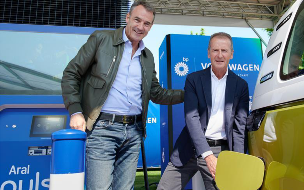 two men at an EV charging station