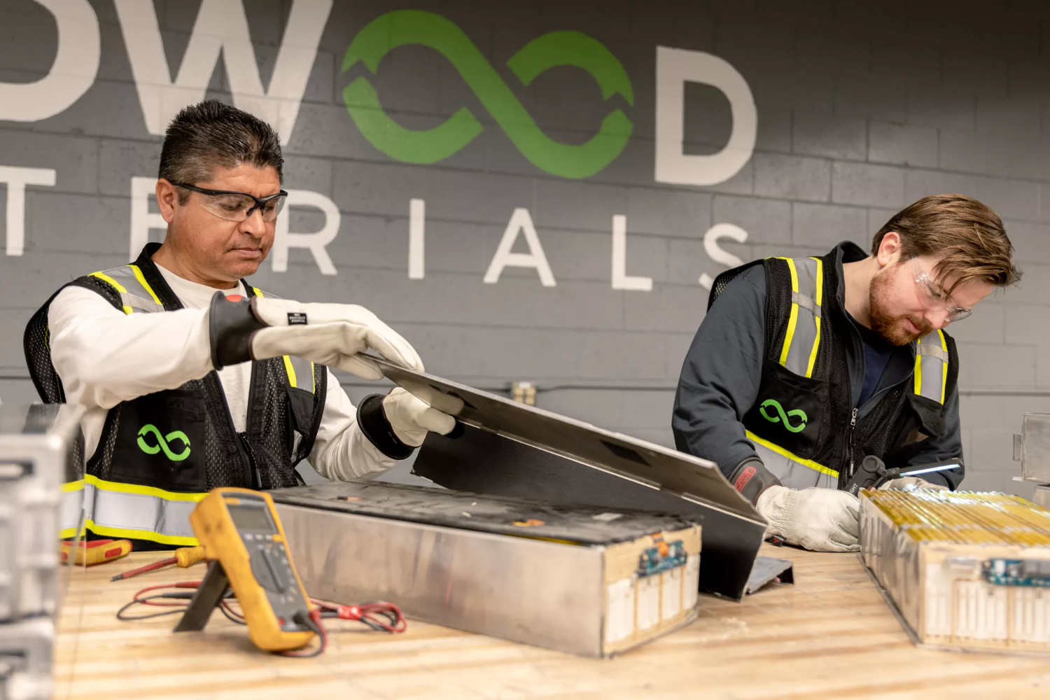 men recycling batteries