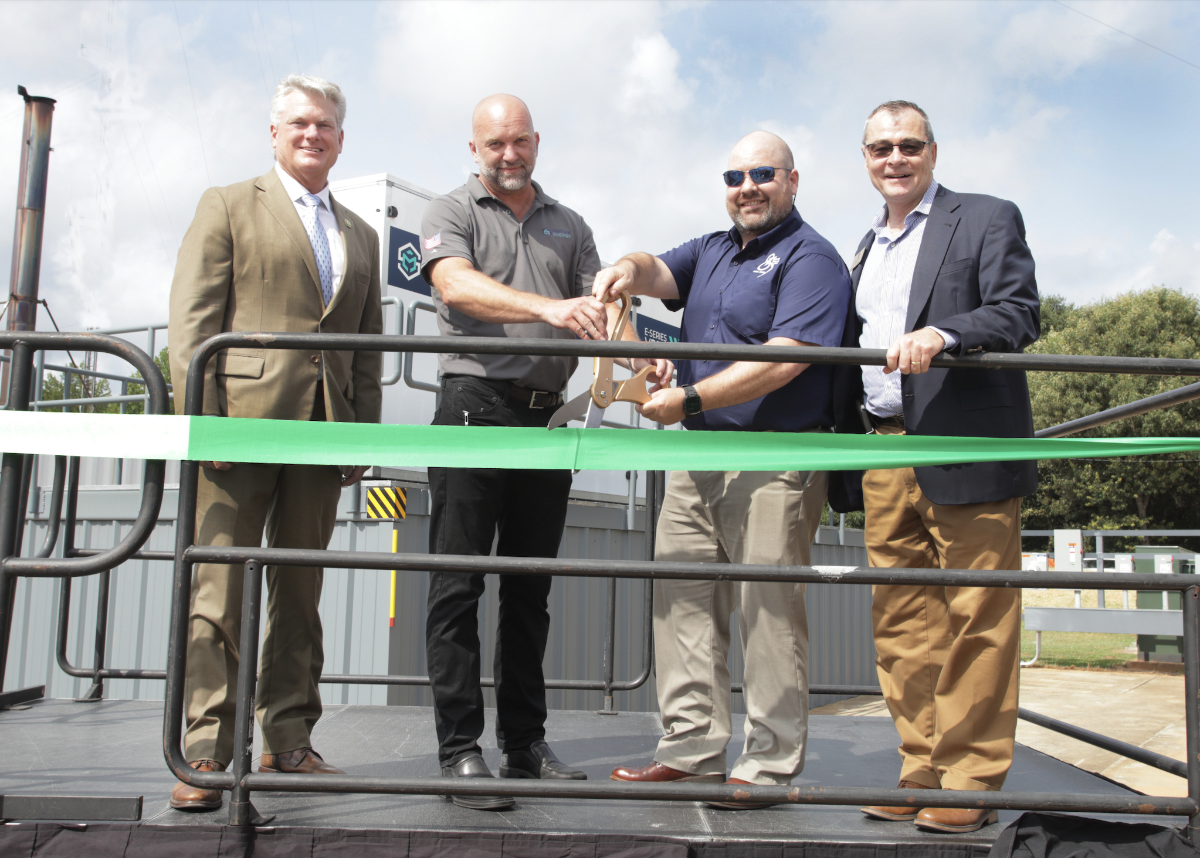 men cutting ribbon