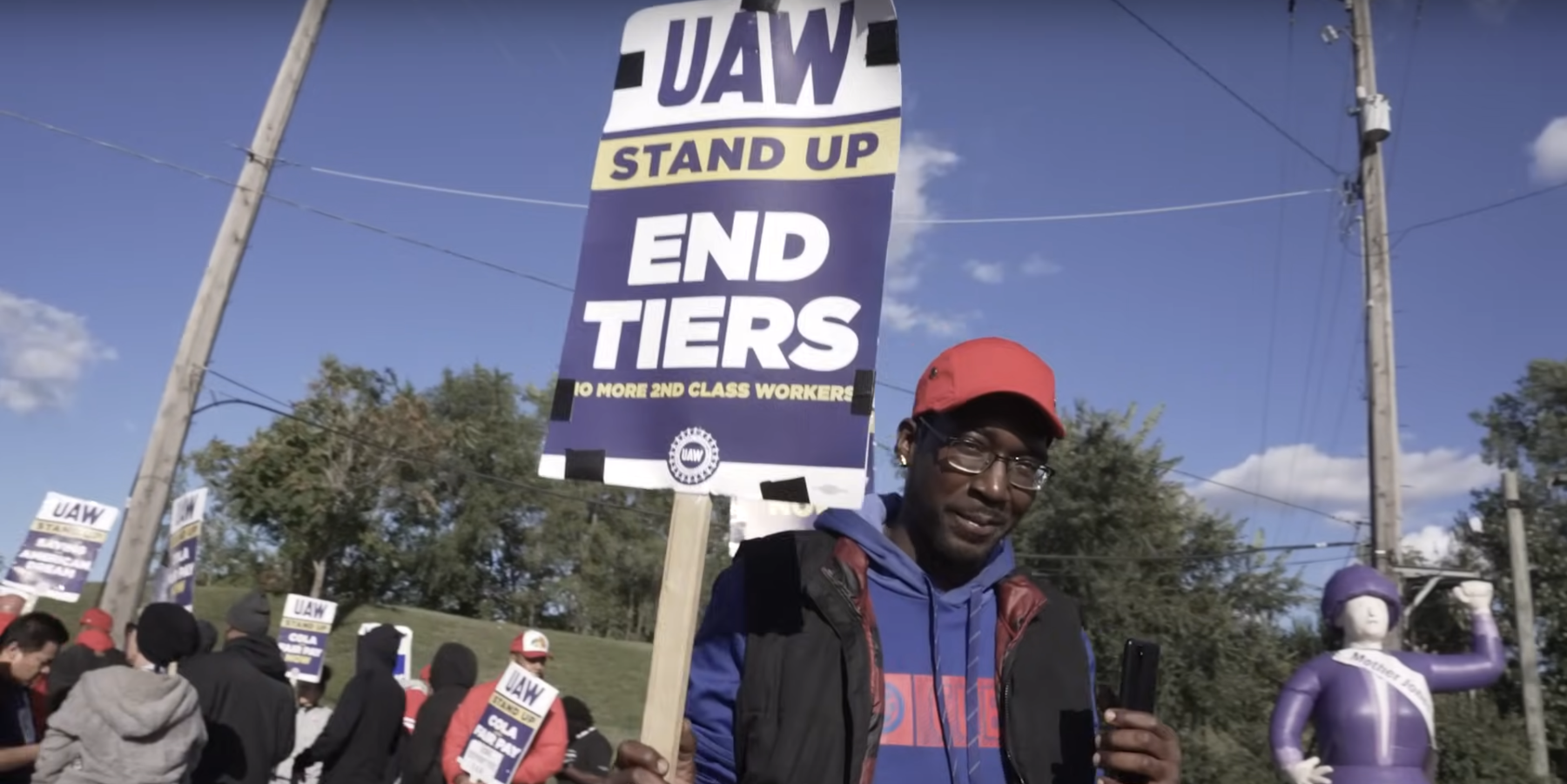 striking workers holding placards