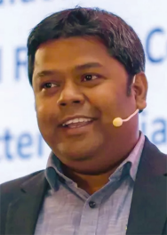 man speaking at a conference