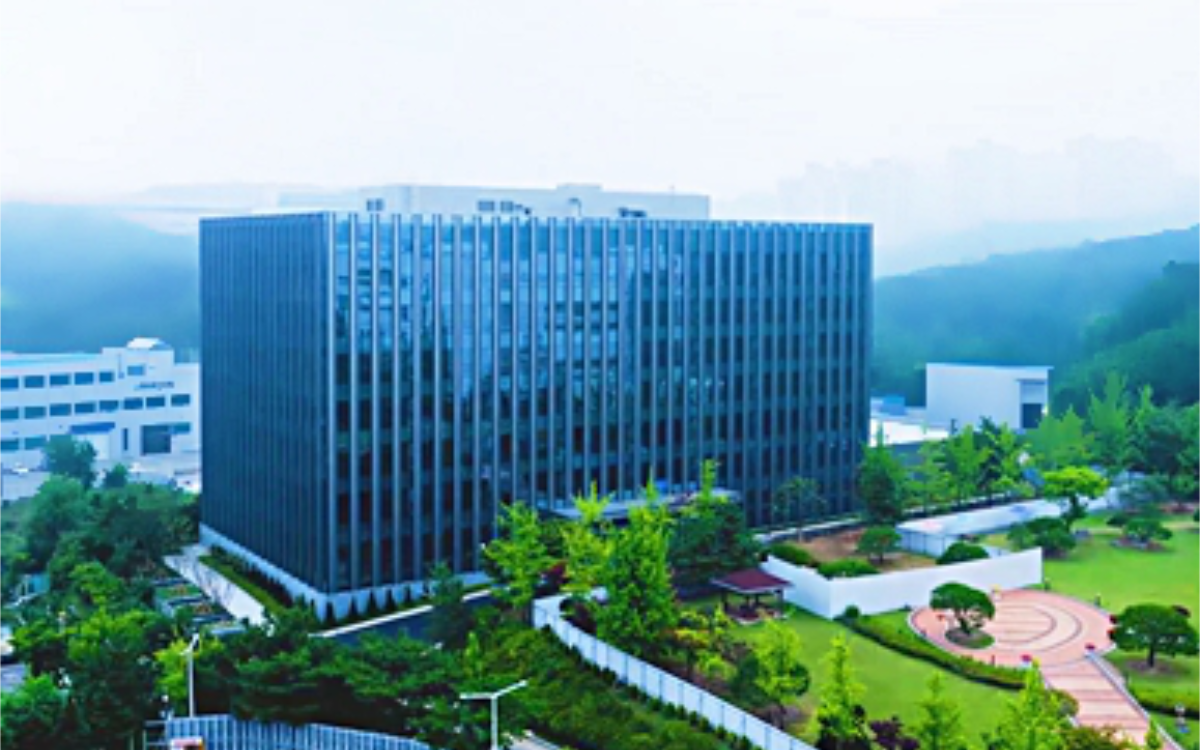 office building with trees and park in front