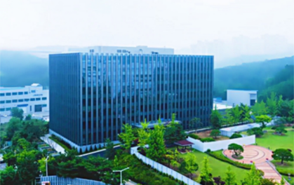 office building with trees and park in front