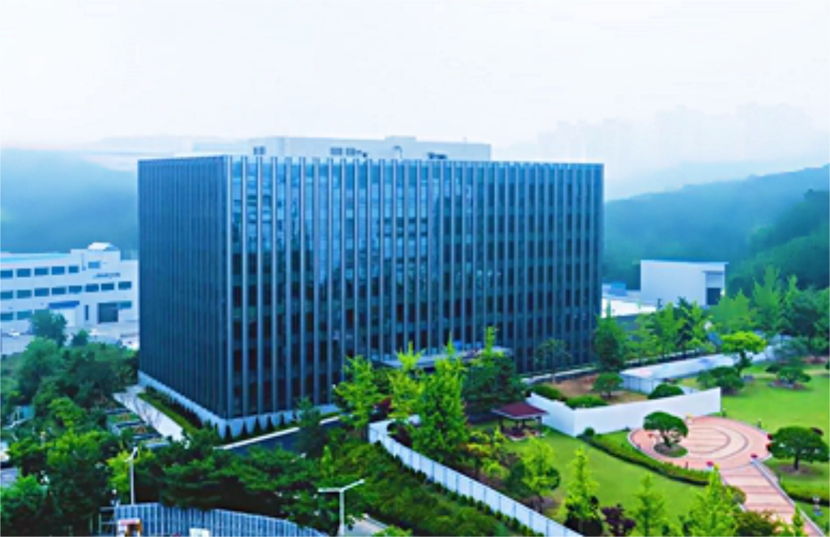 office building with trees and park in front
