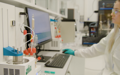 woman at a computer in a lab coat