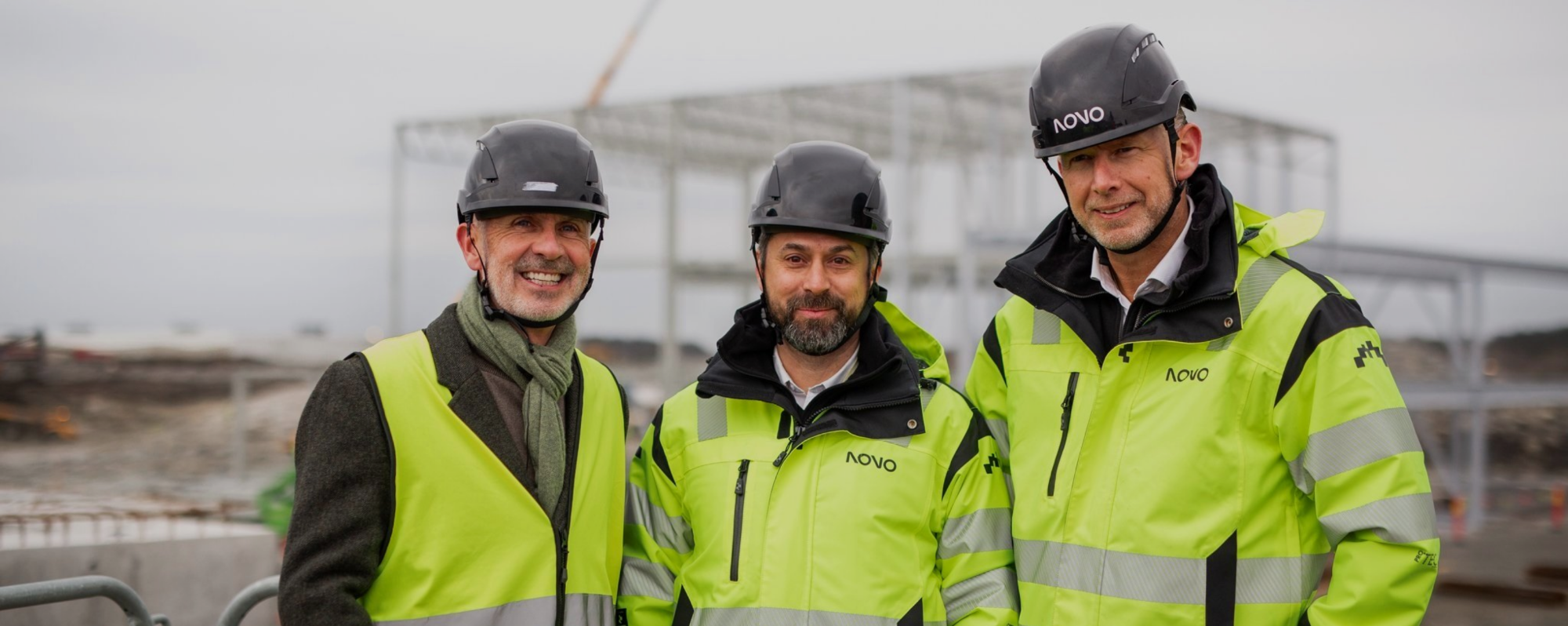 3 men in hi-vis coats on construction site