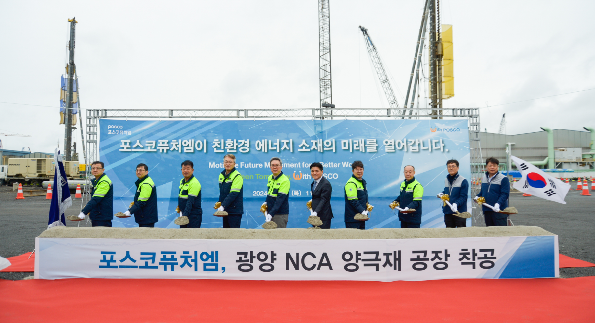 men holding shovels at groundbreaking ceremony