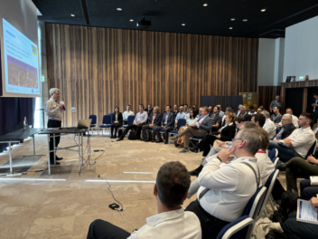 man giving lecture to room full of people