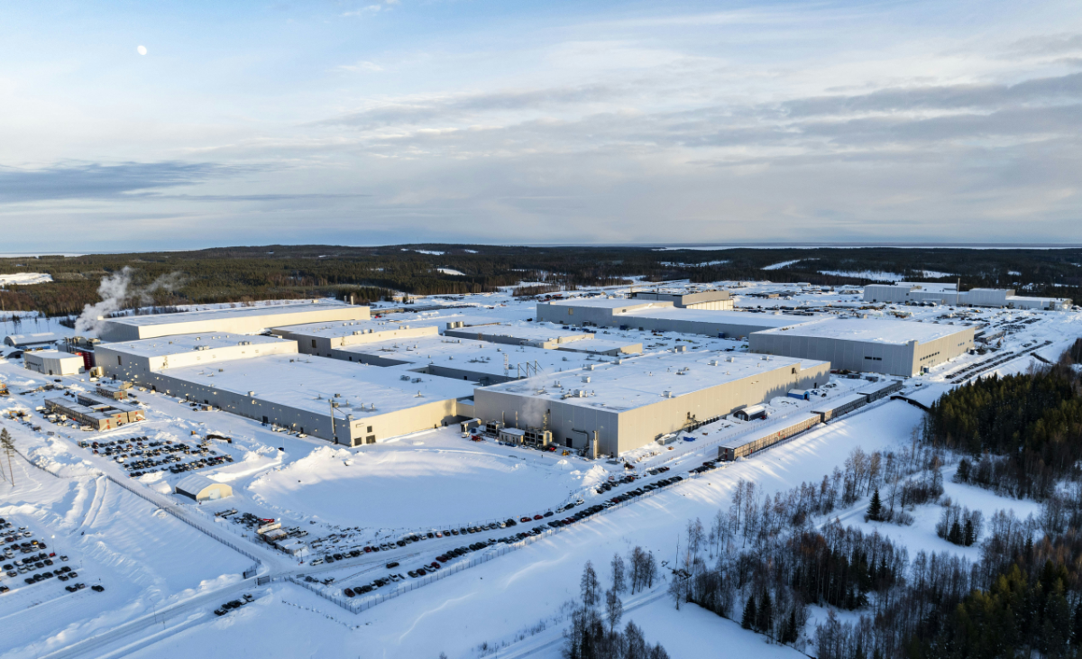 aerial view of gigafactory surrounded by snow