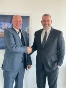 two men in suits shaking hands