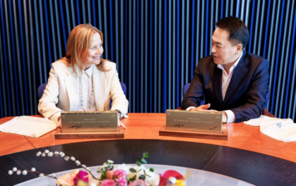 a woman and a man looking at each seated at a table