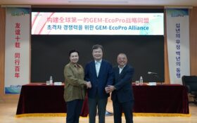 three smiling men at signing ceremony