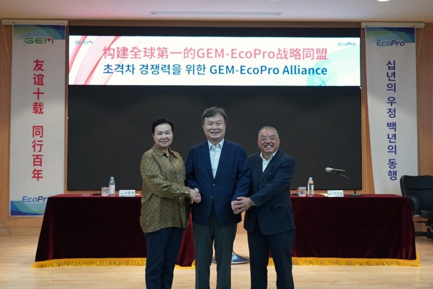 three smiling men at signing ceremony
