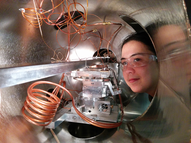woman peers into a chamber