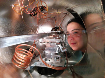 Argonne National Laboratory chemist Karena Chapman peers inside the vacuum tank of the new high-energy Si Laue monochromator recently installed on x-ray beamline 11-ID-B of the Argonne Advanced Photon Source. Photo: Peter Chupas, Argonne National Laboratory
