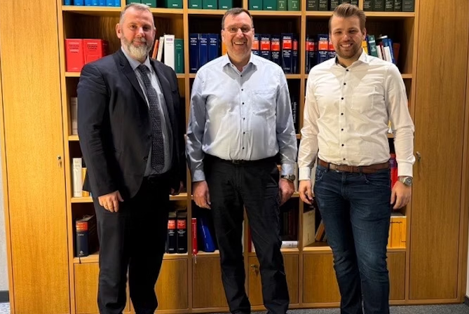 3 men in front of a bookcase