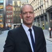 man on street in jacket, shirt and tie