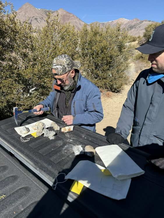 man examining rock samples